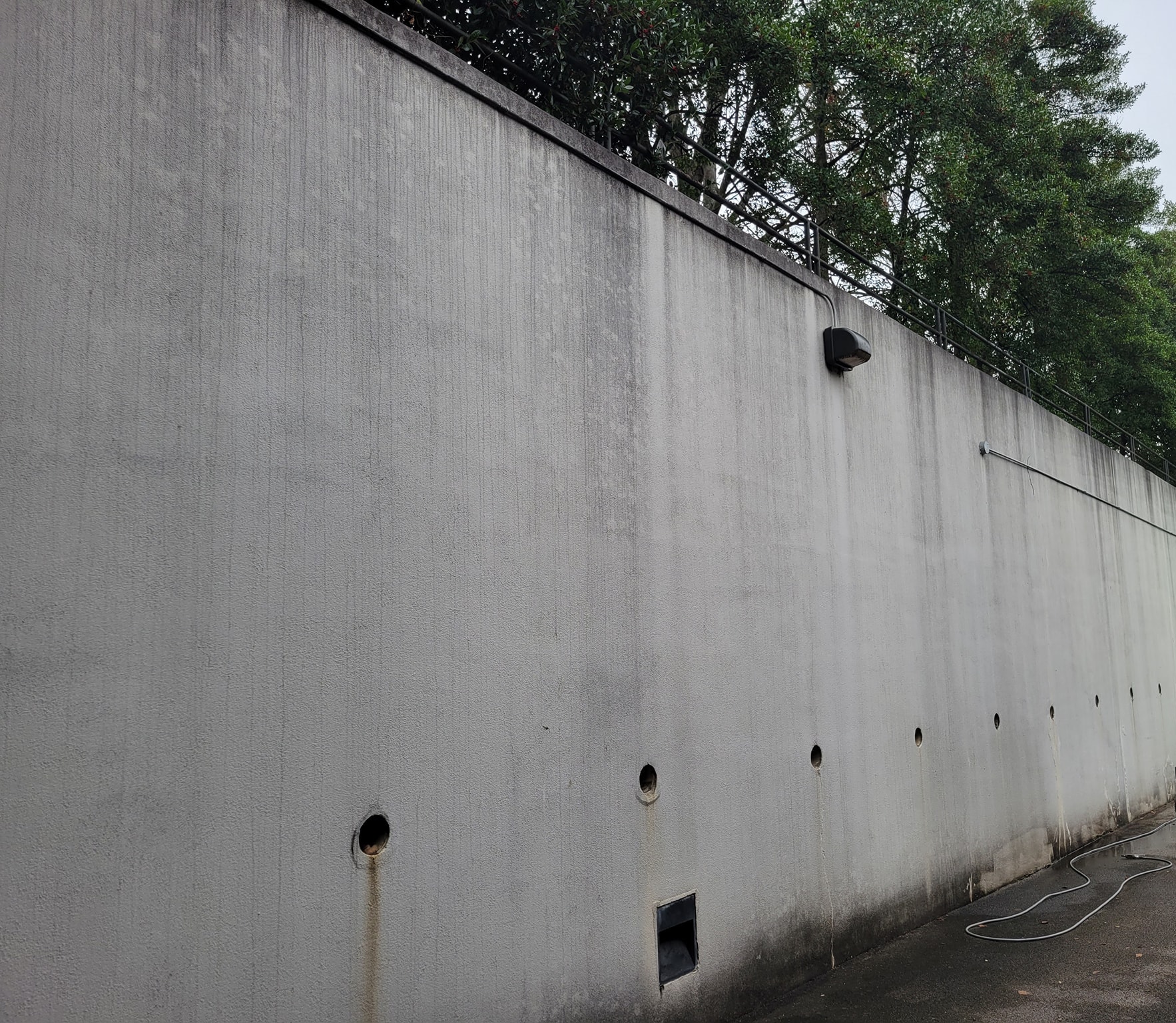 Commercial retaining wall before cleaning