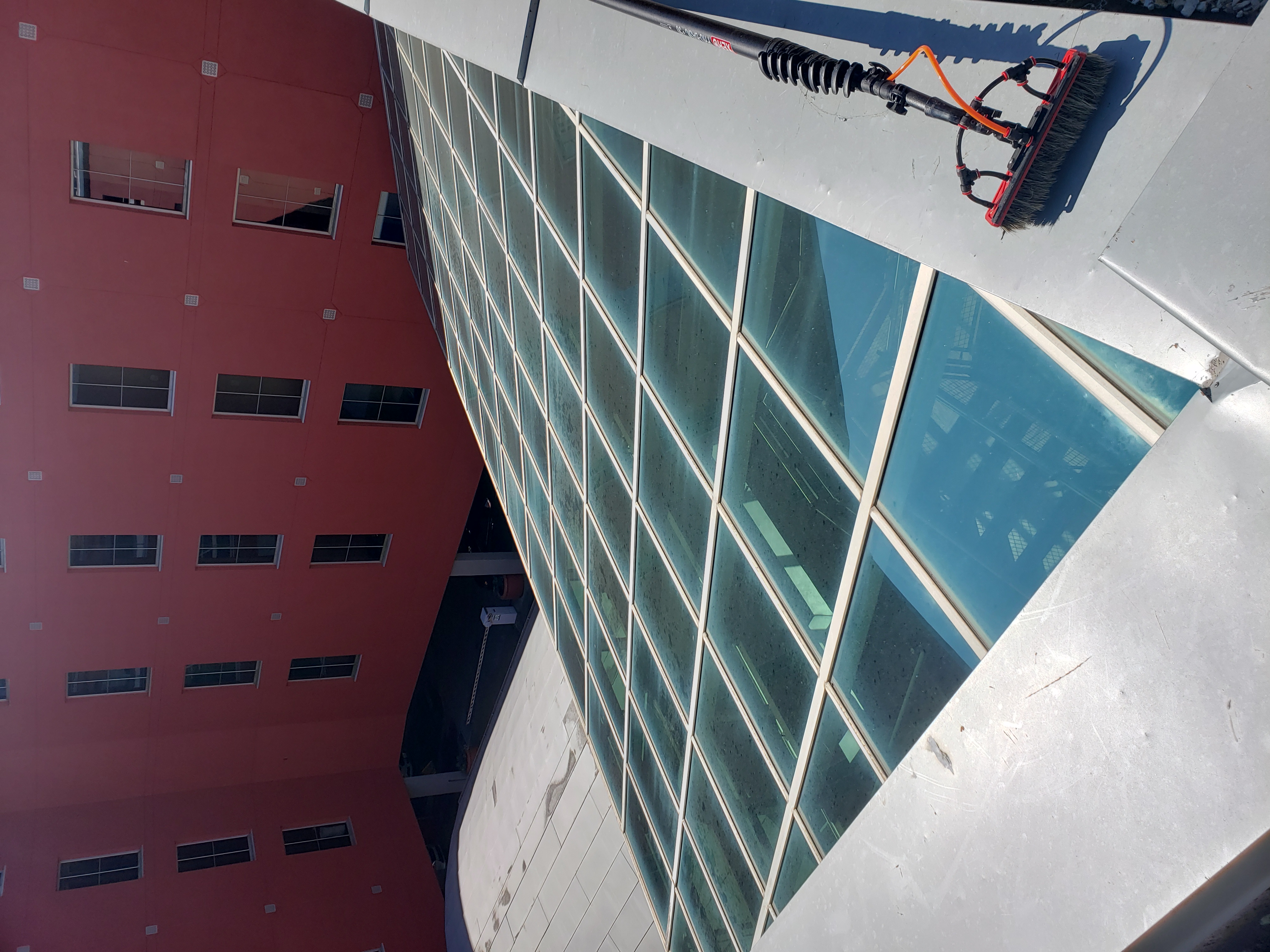 Commercial glass before water-fed pole window cleaning